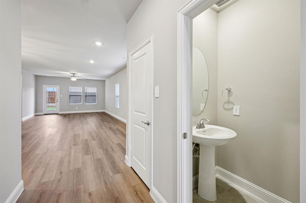 1721 Arches Road Anna, TX 75409 - Photo 6 of 39 a view of a hallway with wooden floor and staircase