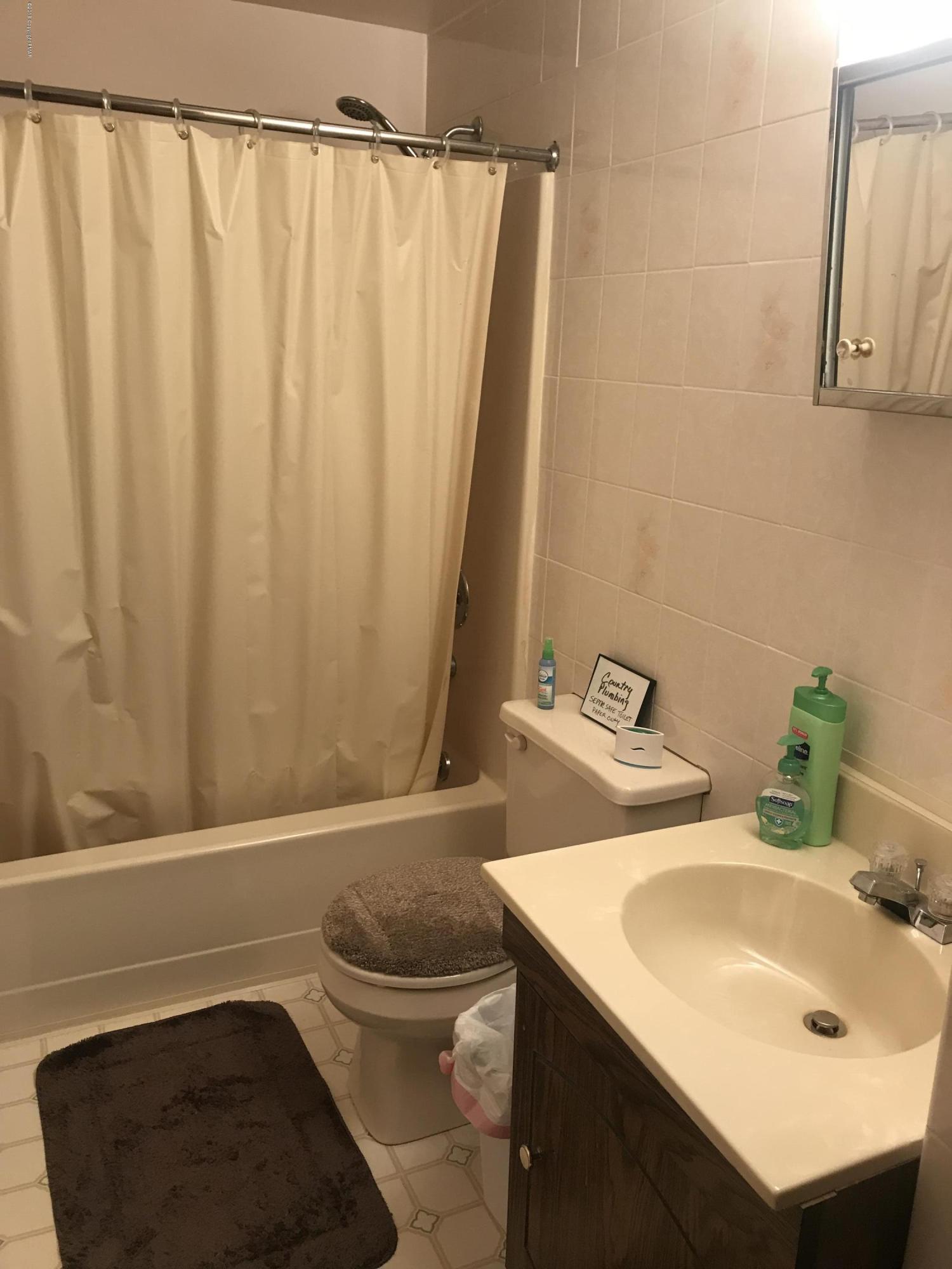 223 Pontiac Path Pocono Lake, PA 18347 - Photo 11 of 13 a bathroom with a sink and a mirror
