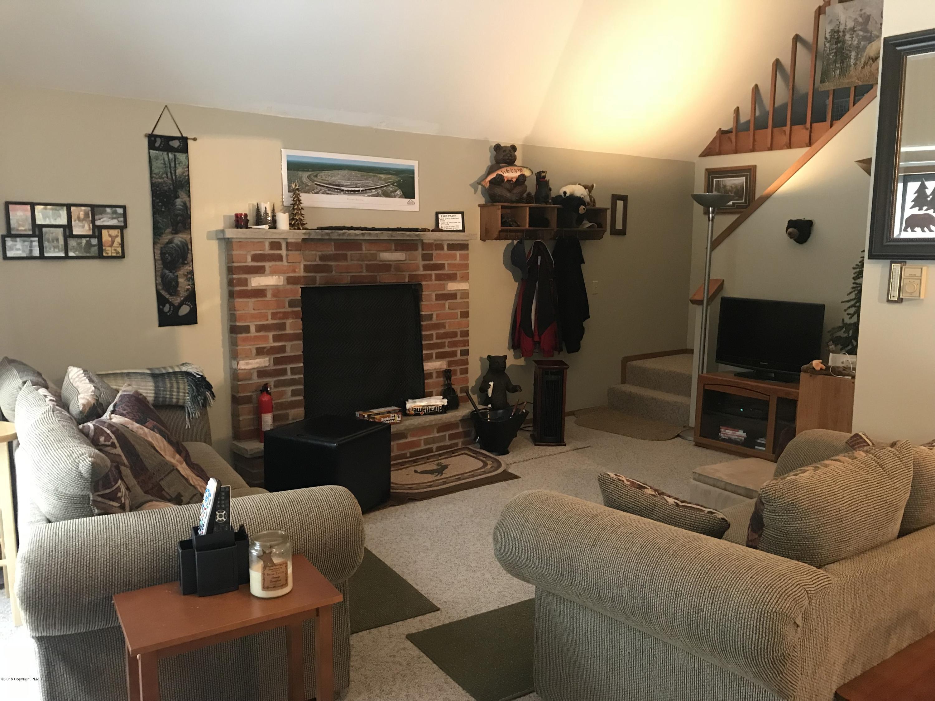 223 Pontiac Path Pocono Lake, PA 18347 - Photo 3 of 13 a living room with furniture and a fireplace