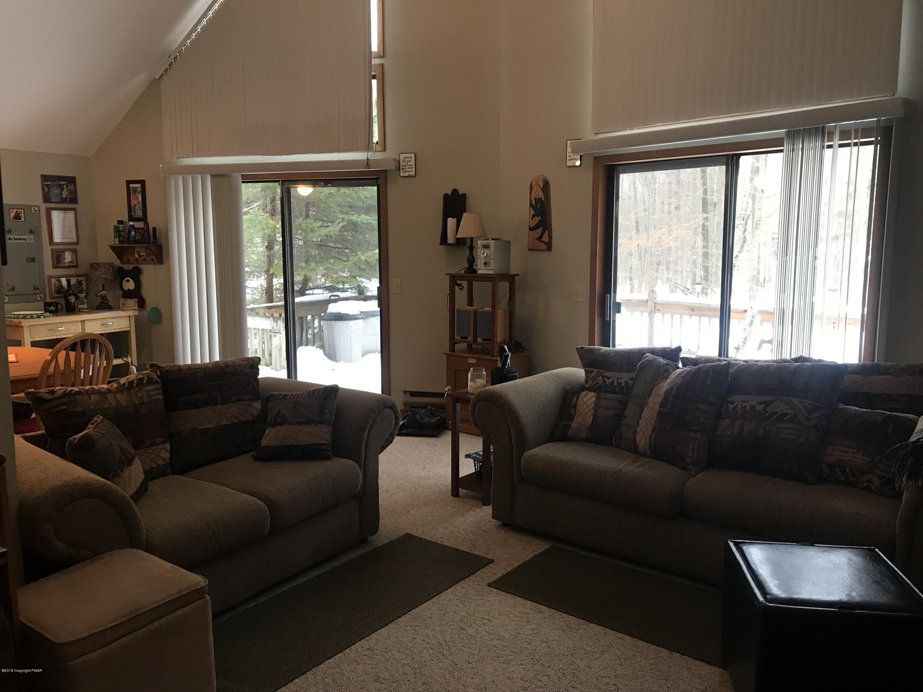 223 Pontiac Path Pocono Lake, PA 18347 - Photo 5 of 13 a living room with furniture and a large window