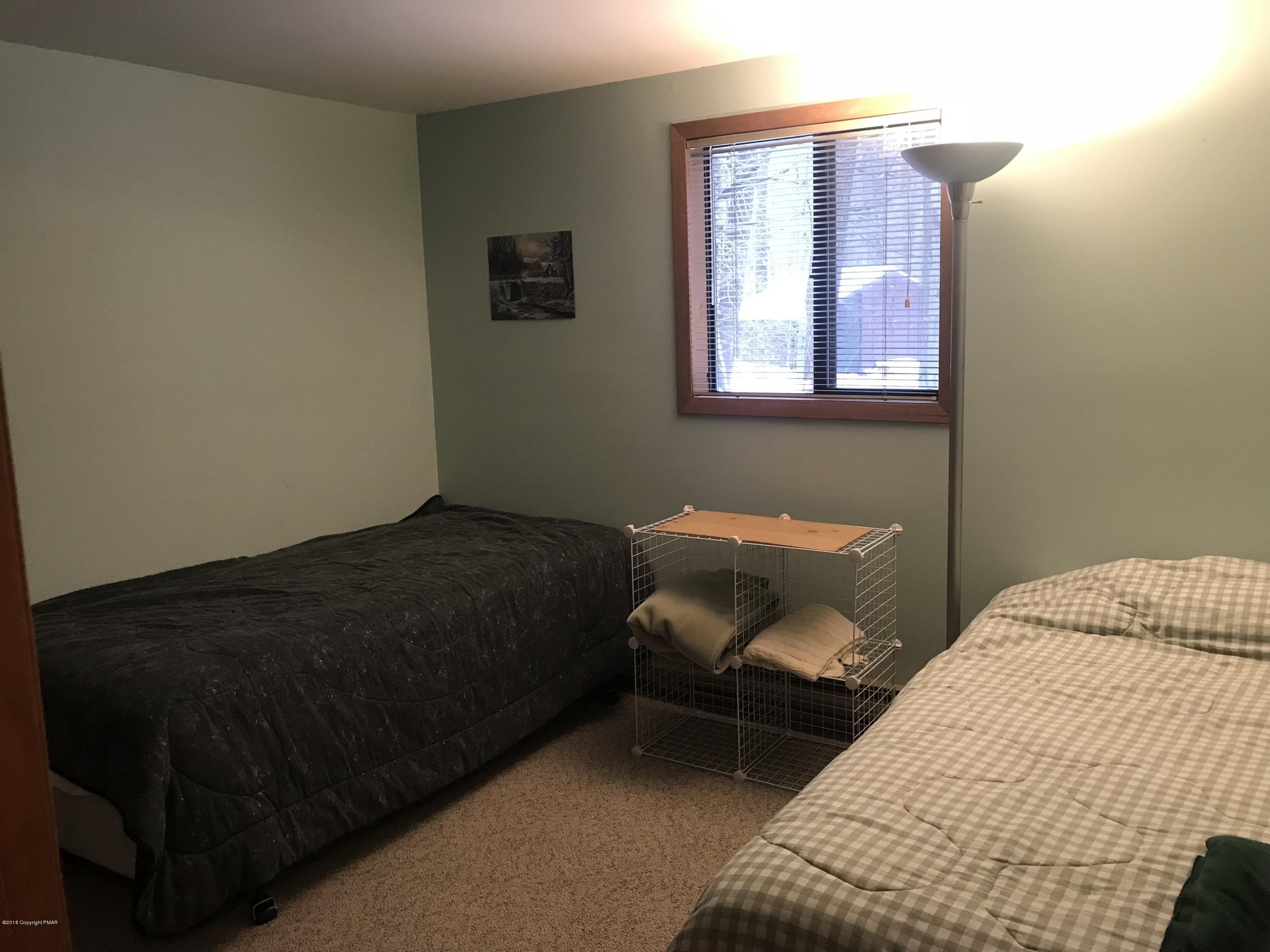 223 Pontiac Path Pocono Lake, PA 18347 - Photo 8 of 13 a bedroom with a bed and window