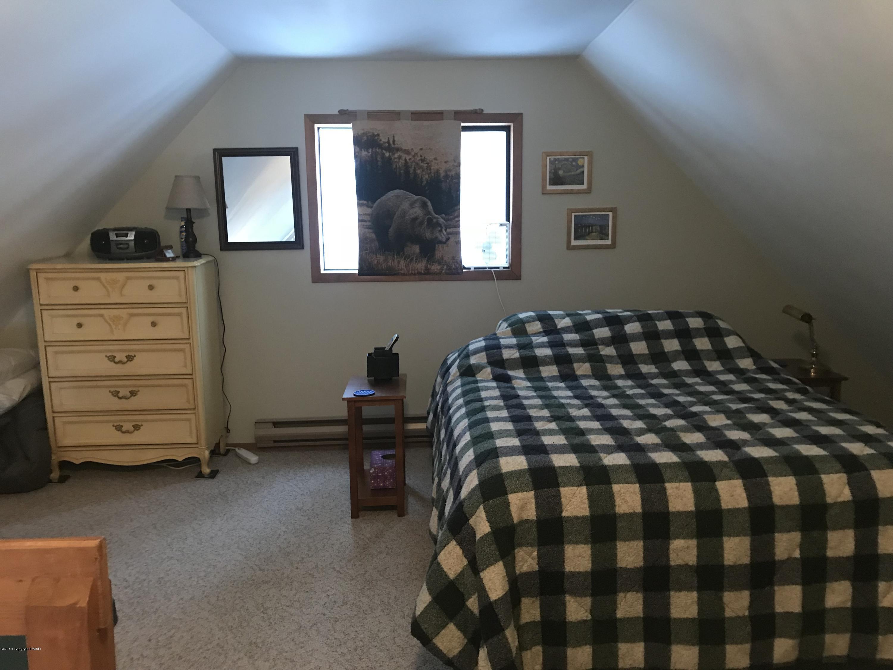 223 Pontiac Path Pocono Lake, PA 18347 - Photo 10 of 13 a bedroom with a bed and a dresser