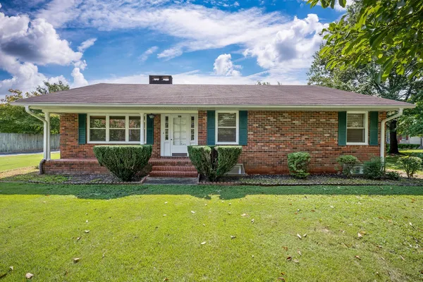 a view of a house with a yard and plants