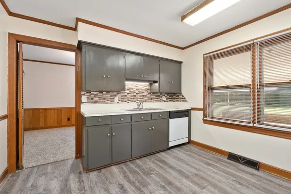 a kitchen with a sink stove and cabinets