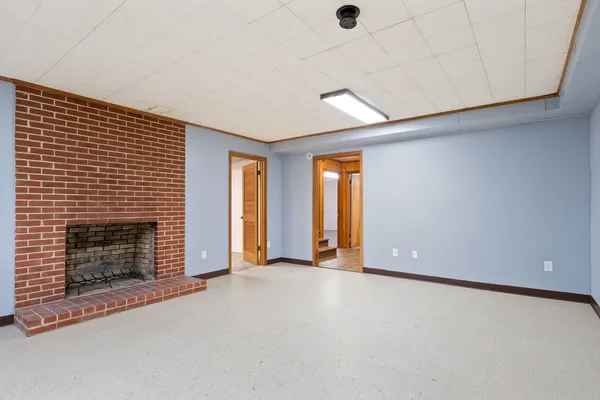 a view of an empty room with a fireplace