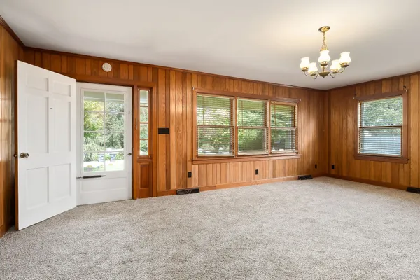 a view of an empty room with a fireplace and a window