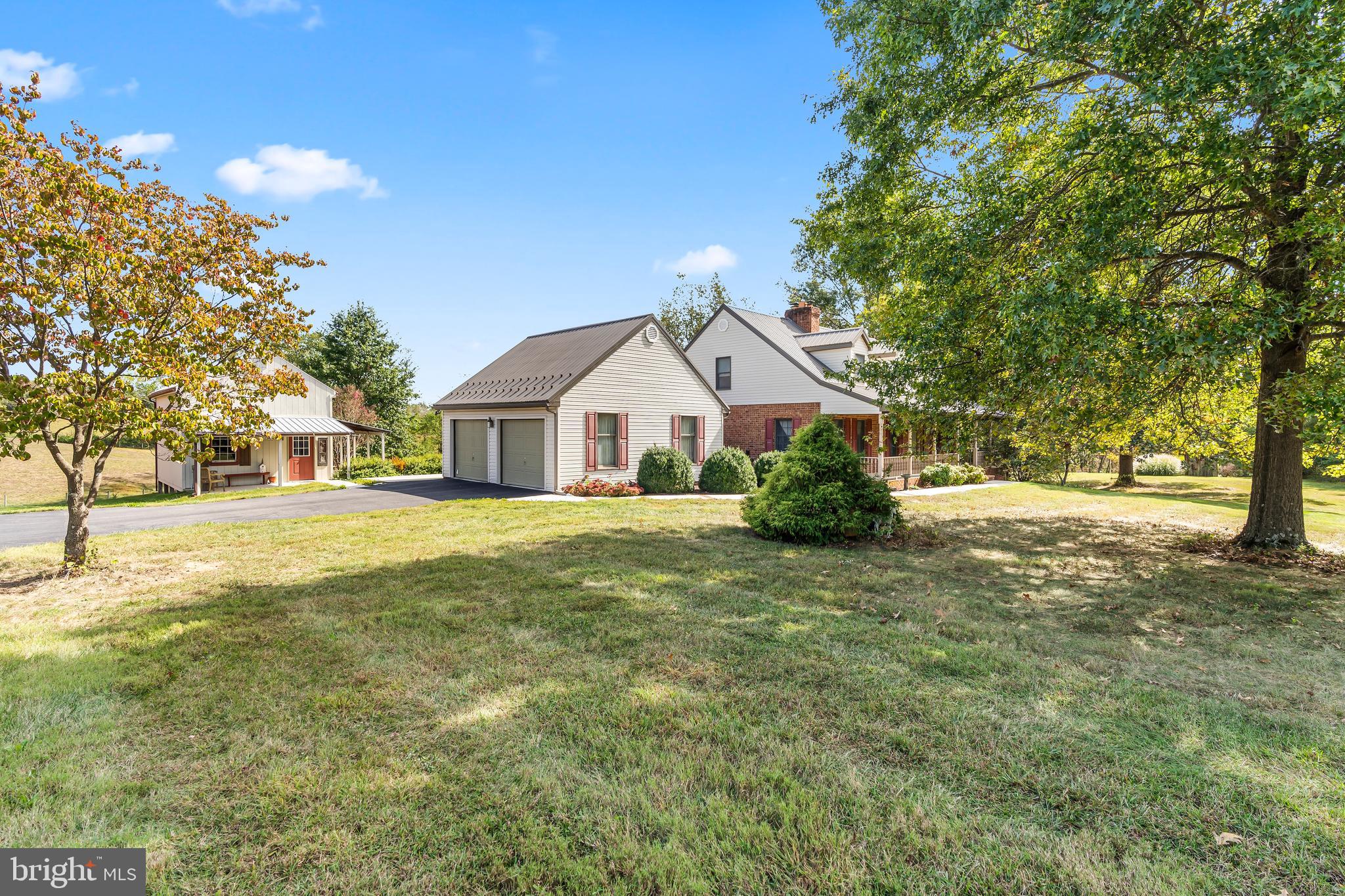 11625 Walnut Point Road Hagerstown, MD 21740 - Photo 115 of 118 a front view of a house with a yard and trees