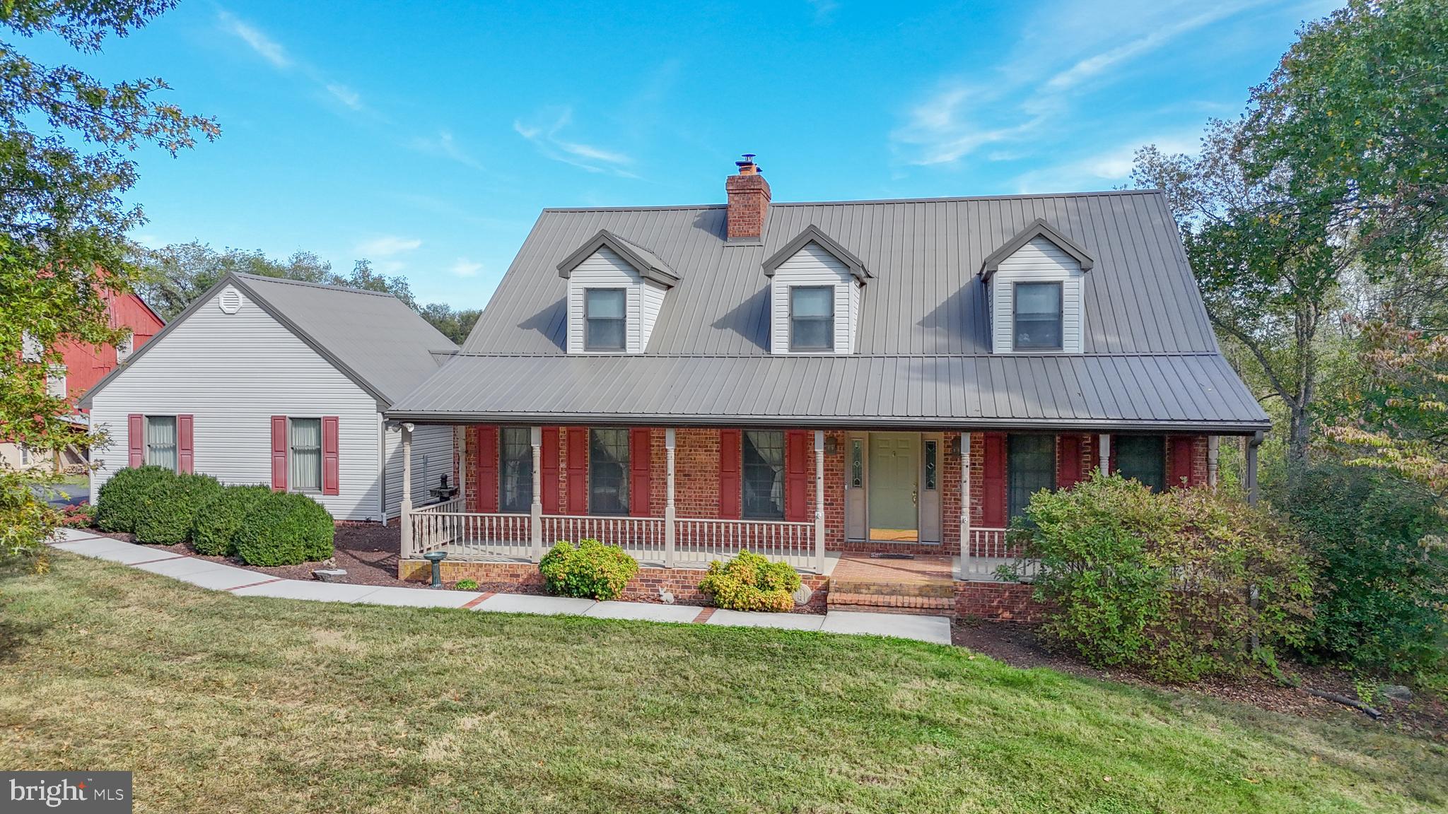 11625 Walnut Point Road Hagerstown, MD 21740 - Photo 5 of 118 a front view of a house with a yard and garage