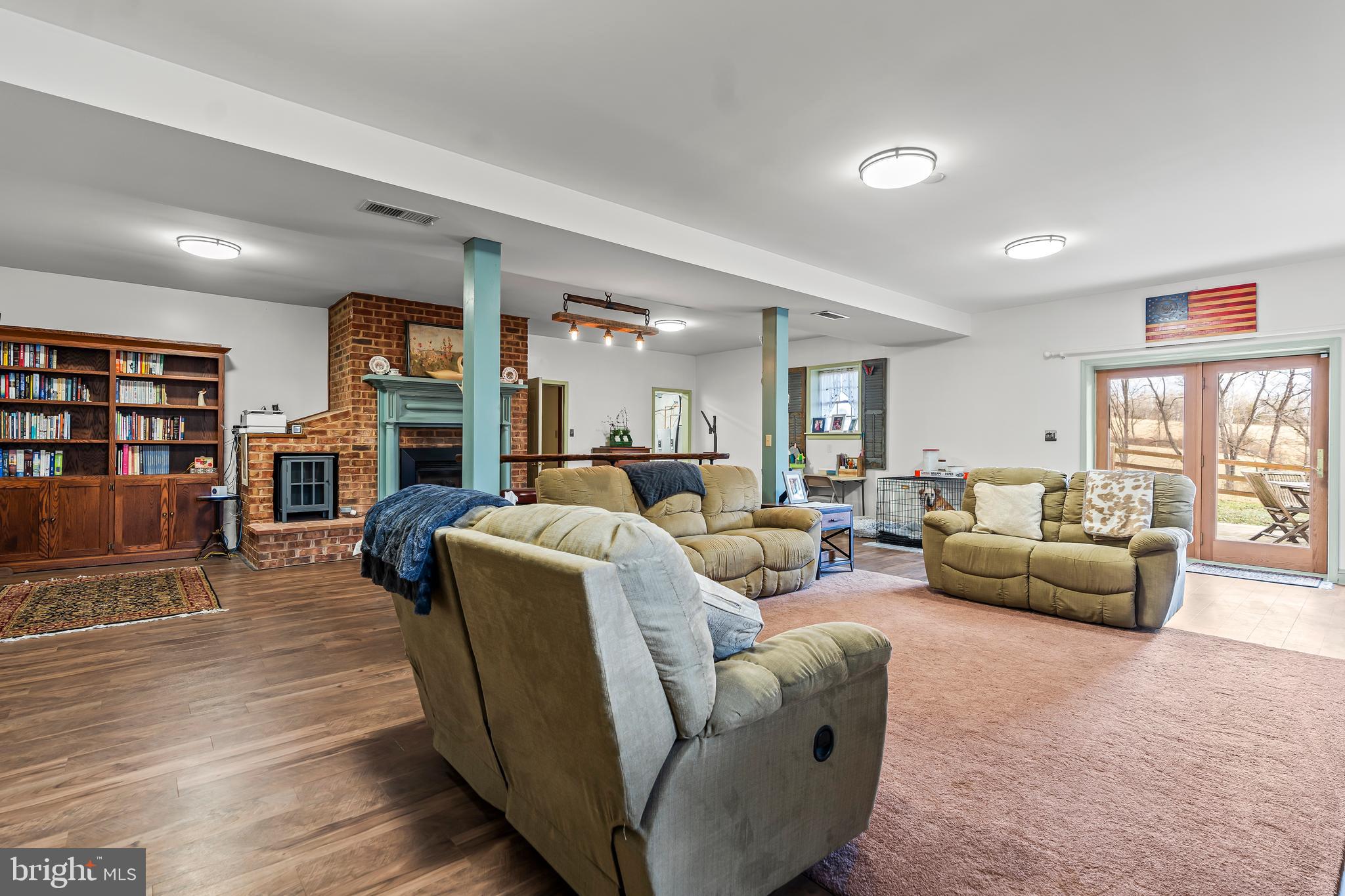 11625 Walnut Point Road Hagerstown, MD 21740 - Photo 62 of 118 a living room with furniture a fireplace and a flat screen tv