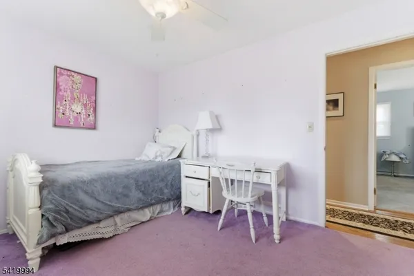 a bedroom with a bed and a table in it