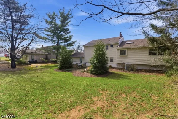 a view of a yard with a house in the background