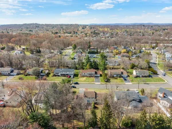 an aerial view of a houses with a yard