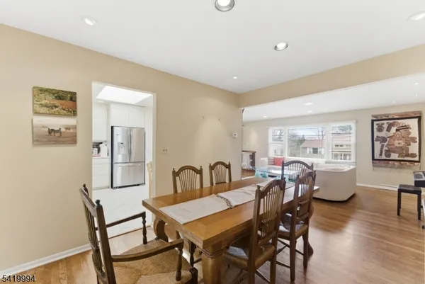 a dining room with furniture a window and wooden floor