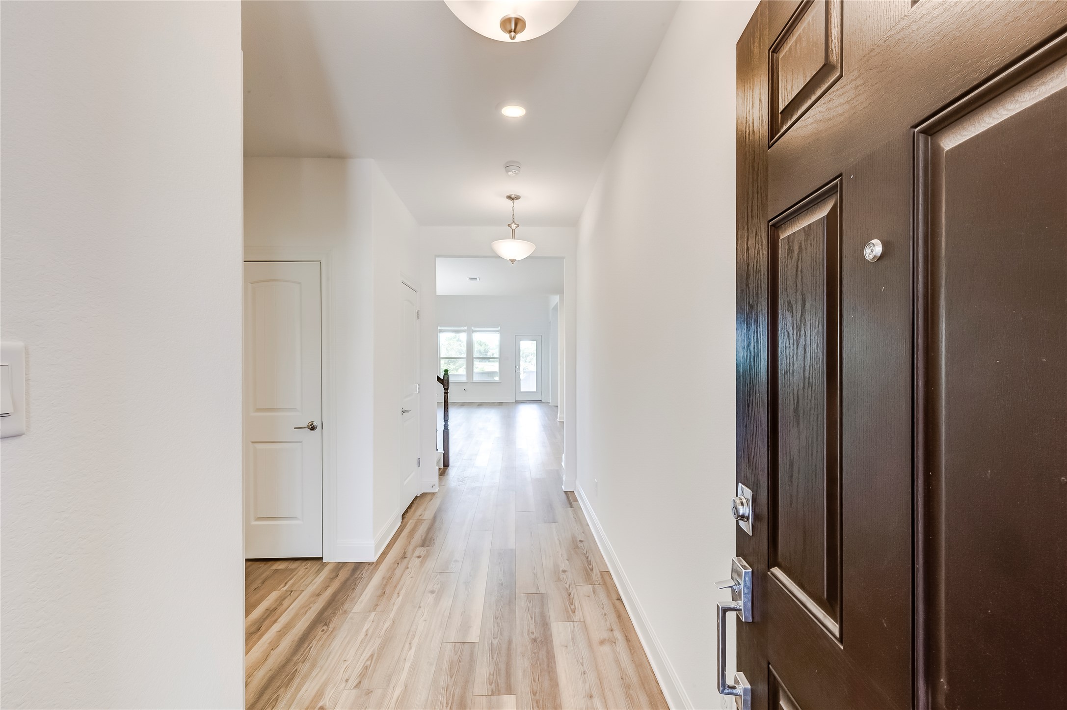 132 Inlet Lane Leander, TX 78641 - Photo 5 of 36 Corridor with light wood-style floors and recessed lighting