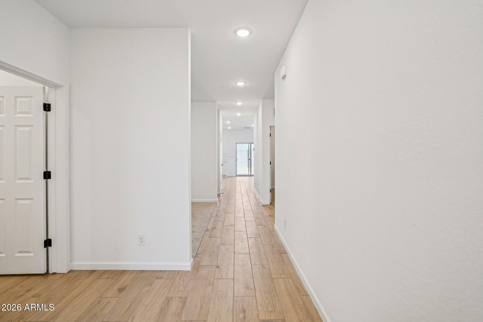 47638 West Moeller Road Maricopa, AZ 85139 - Photo 11 of 56 a view of a hallway with wooden floor