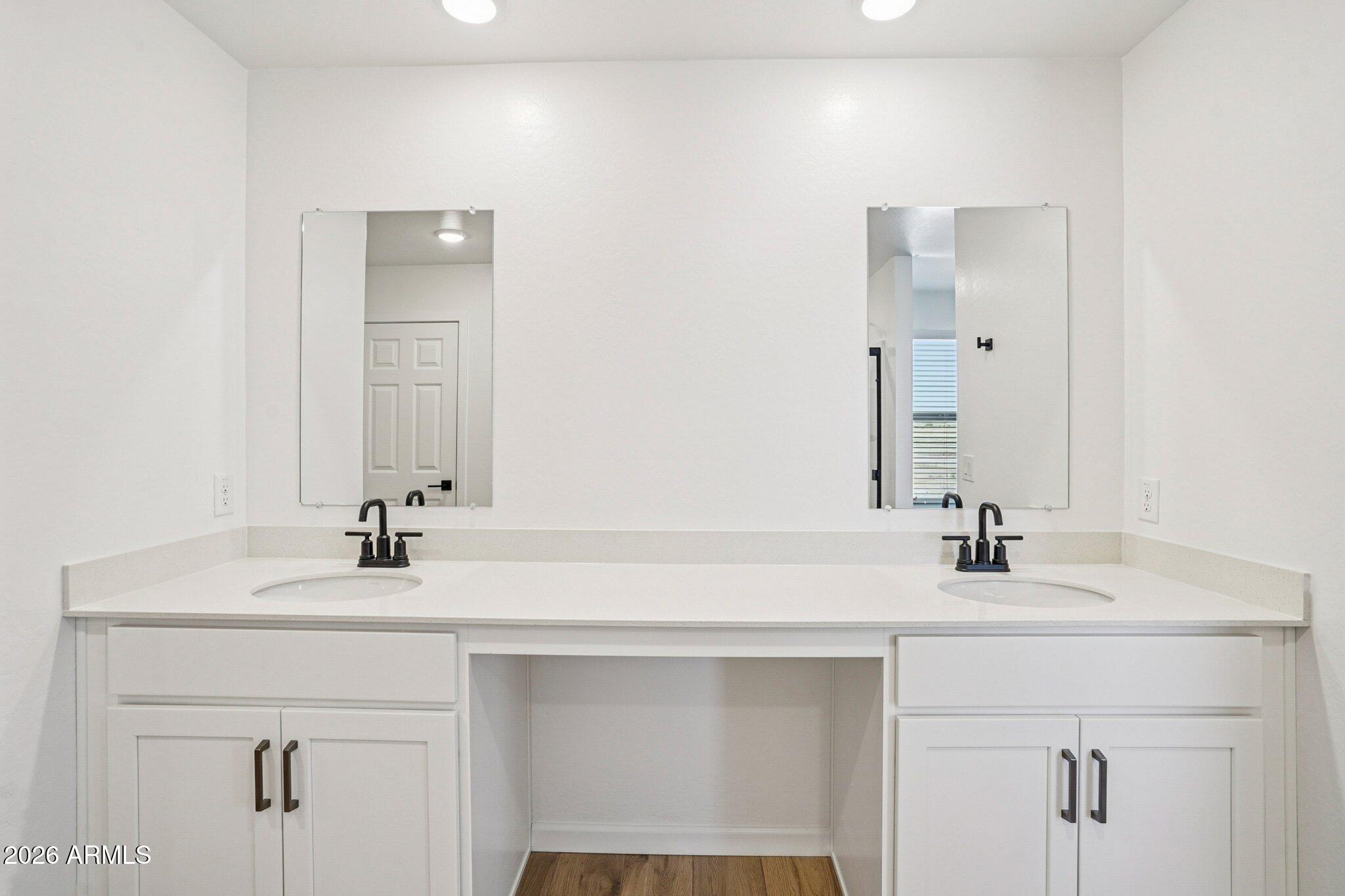47638 West Moeller Road Maricopa, AZ 85139 - Photo 32 of 56 a bathroom with a sink and a mirror