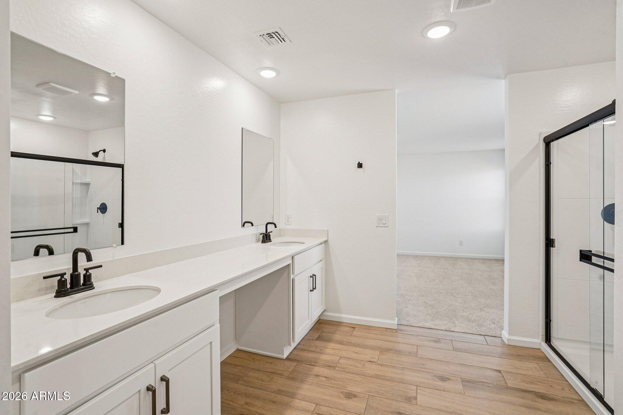 47638 West Moeller Road Maricopa, AZ 85139 - Photo 35 of 56 a bathroom with a double vanity sink and mirror