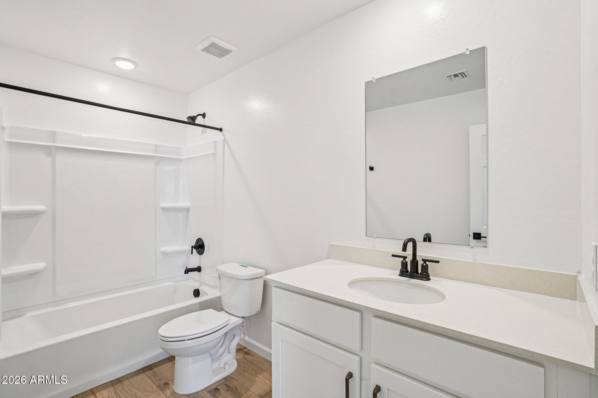 47638 West Moeller Road Maricopa, AZ 85139 - Photo 39 of 56 a bathroom with a sink toilet a mirror and shower
