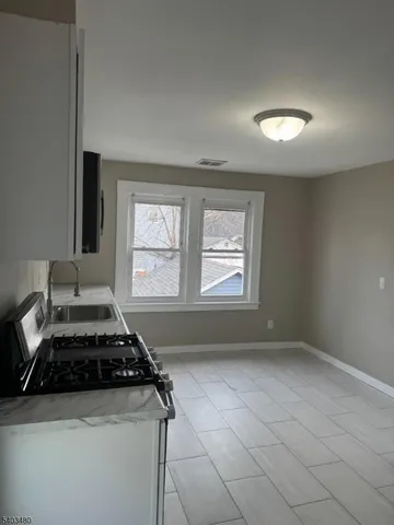 a kitchen with a stove and a window