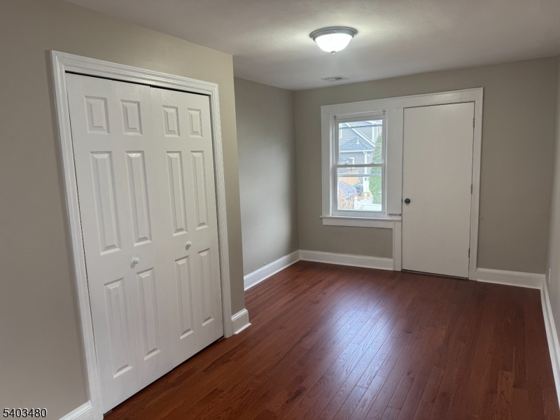 375 Tower Street Union, NJ 07088 - Photo 6 of 10 an empty room with wooden floor and windows