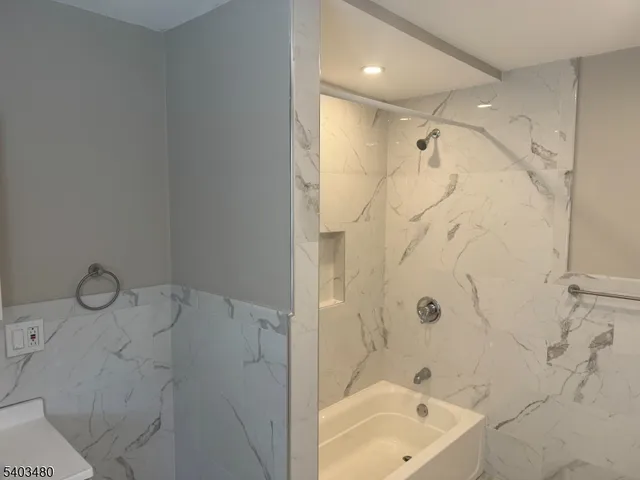 a bathroom with a bathtub and shower