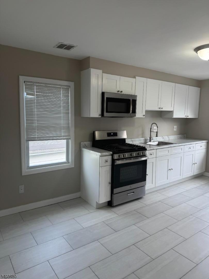 375 Tower Street Union, NJ 07088 - Photo 10 of 10 a kitchen with a stove a sink and a microwave