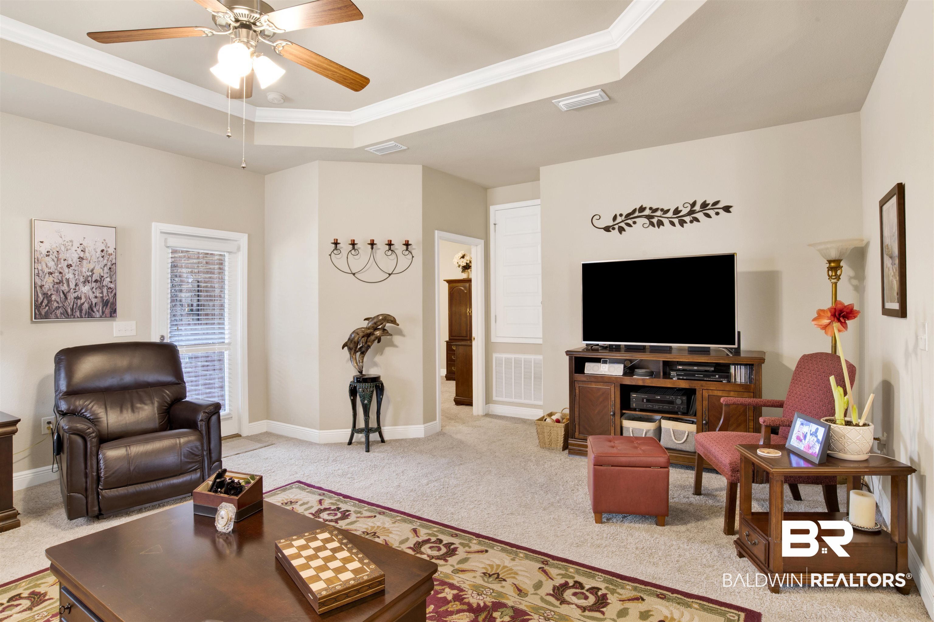 1476 Surrey Loop Foley, AL 36535 - Photo 16 of 31 Carpeted living room with ornamental molding, ceiling fan, and a tray ceiling