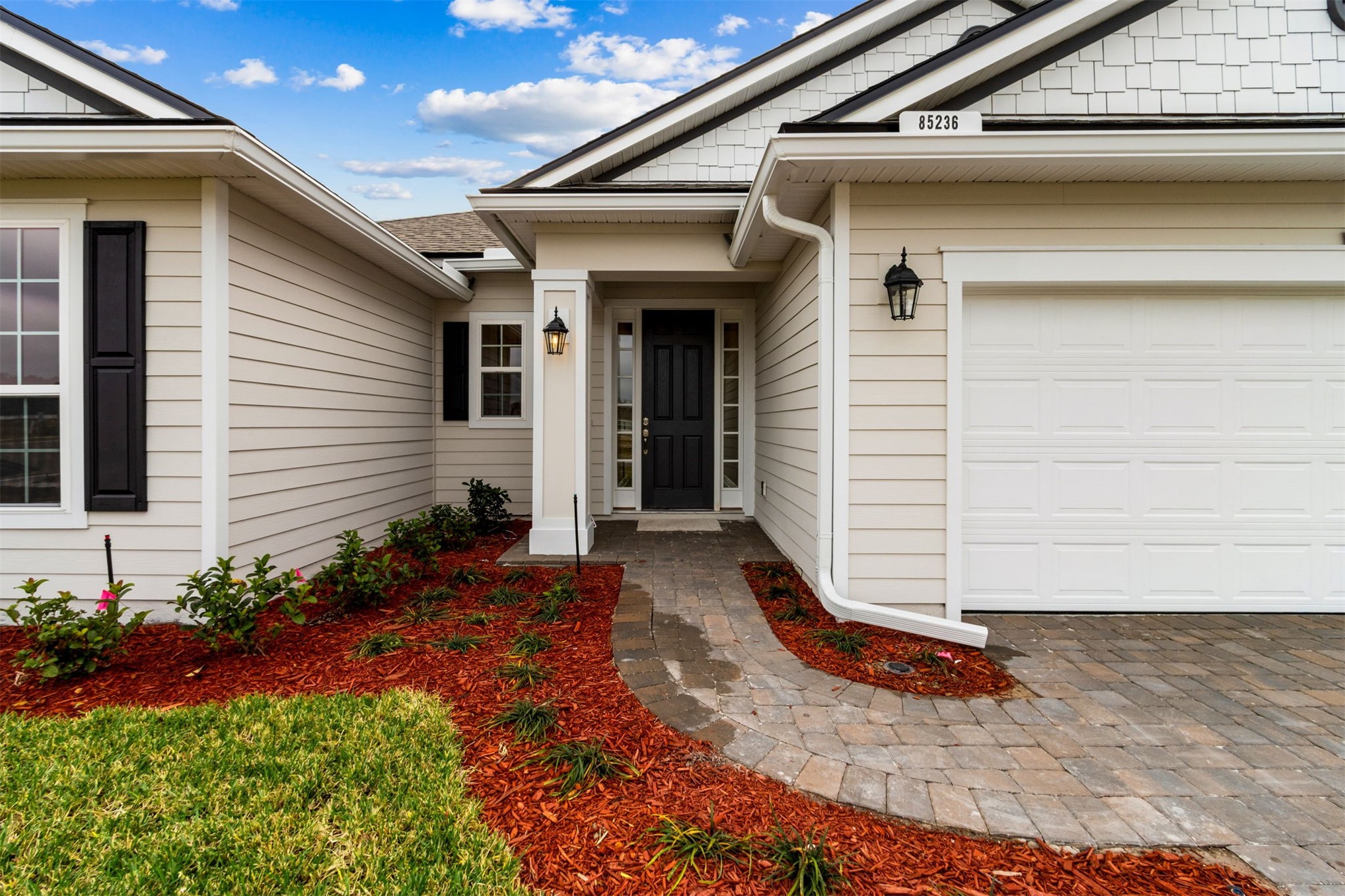 85236 Sandy Rdg Loop Yulee, FL 32097 - Photo 2 of 19 a front view of a house with garden