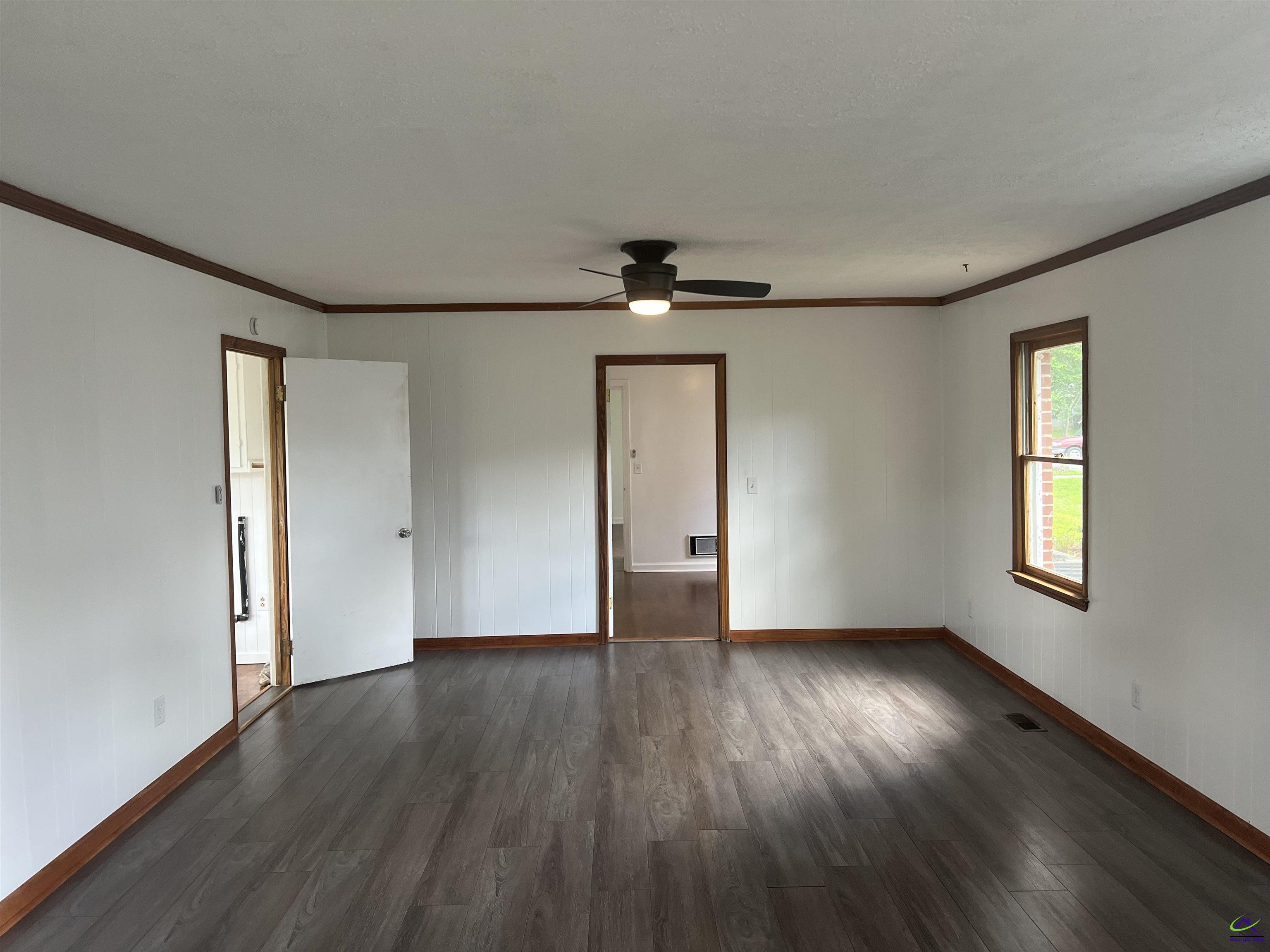 145 South 2nd Street Cochran, GA 31014 - Photo 18 of 24 a view of an empty room with wooden floor and a window