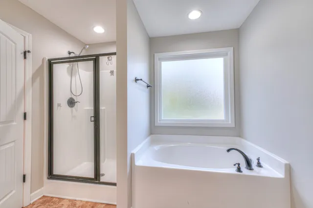 a bathroom with a bathtub and a shower