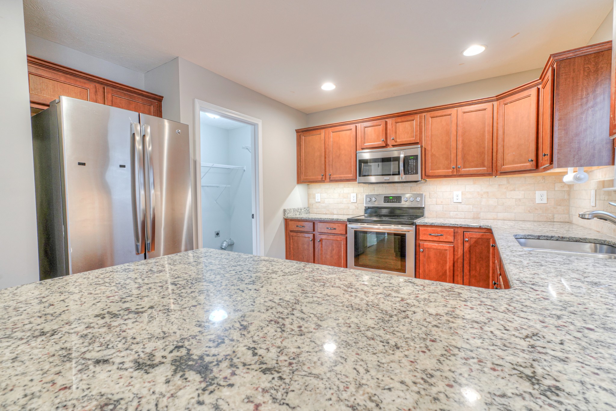 1485 Round Rock Drive Murfreesboro, TN 37128 - Photo 18 of 39 a kitchen with stainless steel appliances granite countertop a refrigerator sink and cabinets
