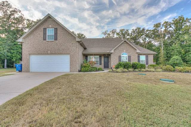 a front view of a house with a yard and garage