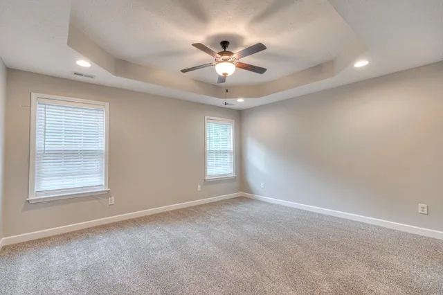 a view of a livingroom with a ceiling fan and window