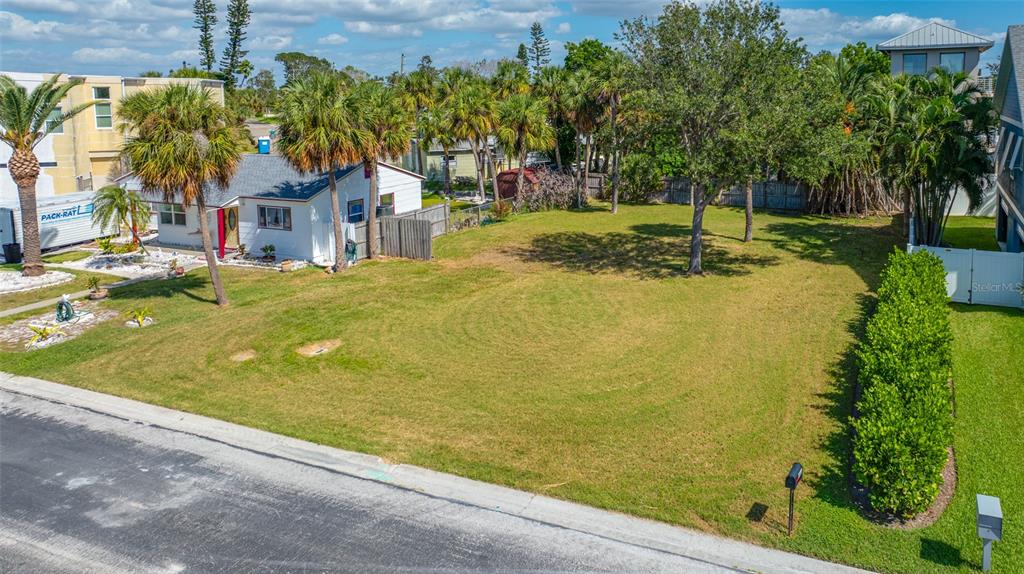 3961 Oleander Way St. Pete Beach, FL 33706 - Photo 7 of 15 a view of swimming pool with a garden and trees