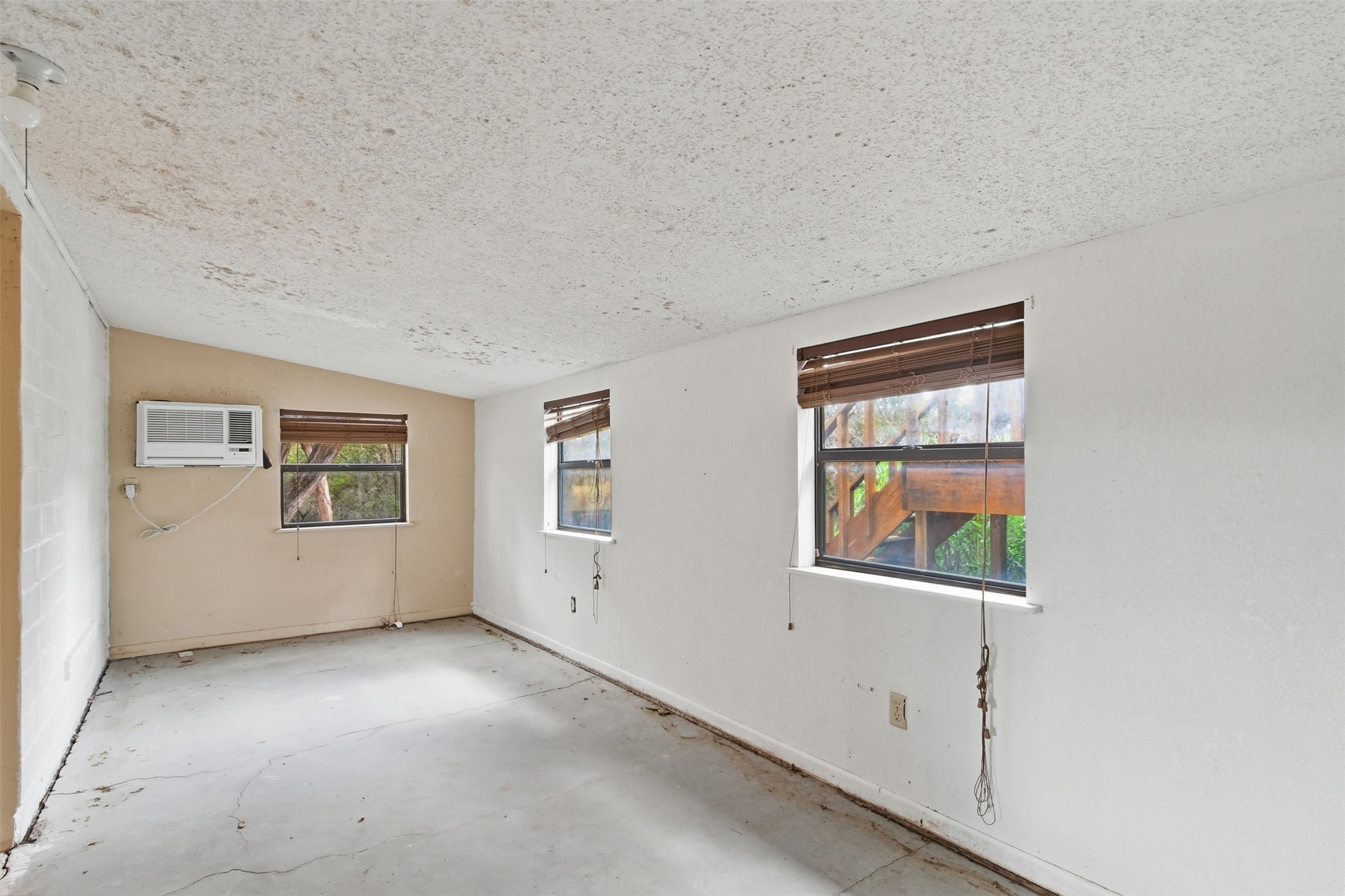1260 Magers Road Concan, TX 78838 - Photo 10 of 40 Bright windows offer verdant outdoor views, creating a tranquil atmosphere in this versatile room.
