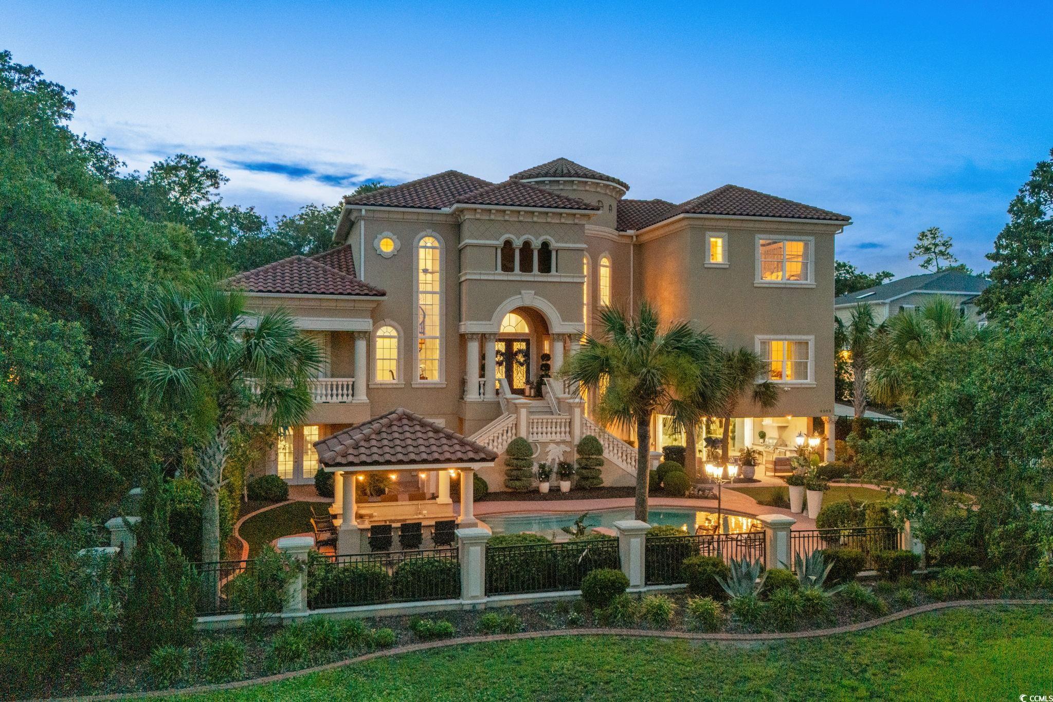 View of front of property featuring a tile roof, stucco siding, a gazebo, and a patio area