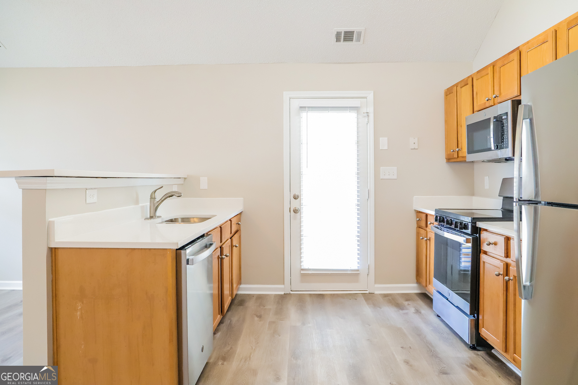 4976 Wolfcreek View South Fulton, GA 30349 - Photo 5 of 17 a view of a kitchen with stainless steel appliances granite countertop a refrigerator and a sink
