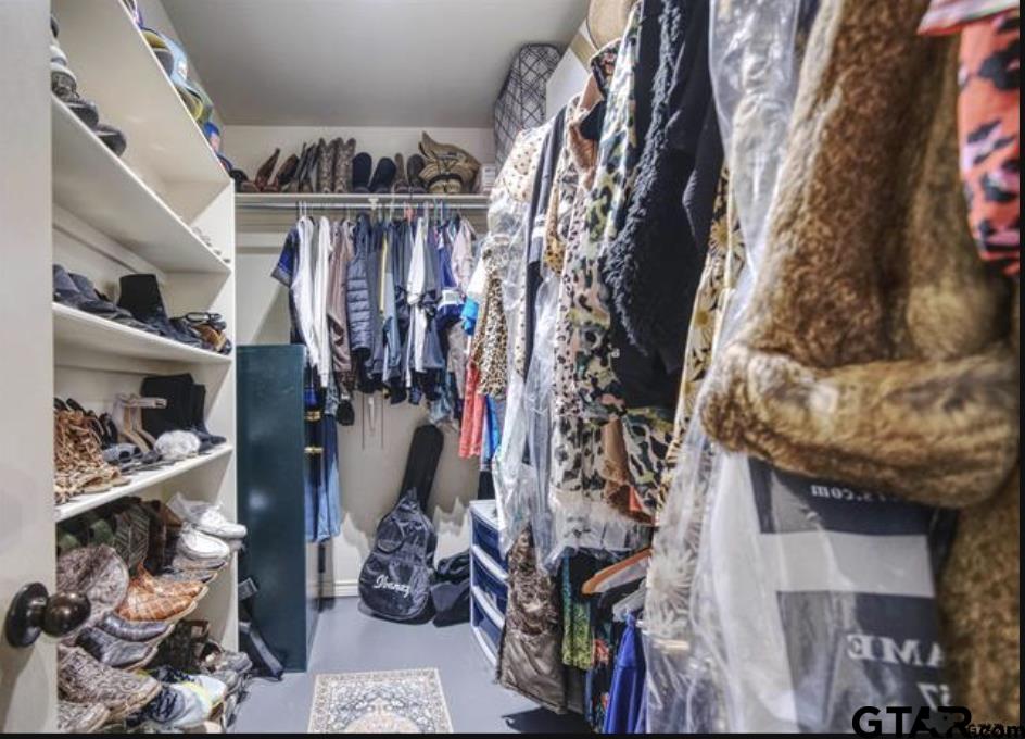 21192 Altuda Lane Flint, TX 75762 - Photo 21 of 46 a view of walk in closet with clothes and shoes