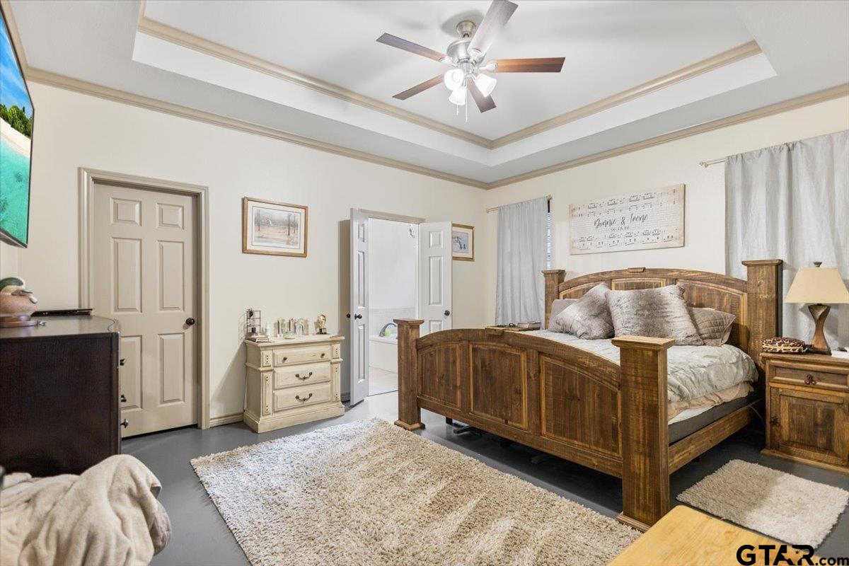 21192 Altuda Lane Flint, TX 75762 - Photo 23 of 46 a spacious bedroom with a bed and a chandelier