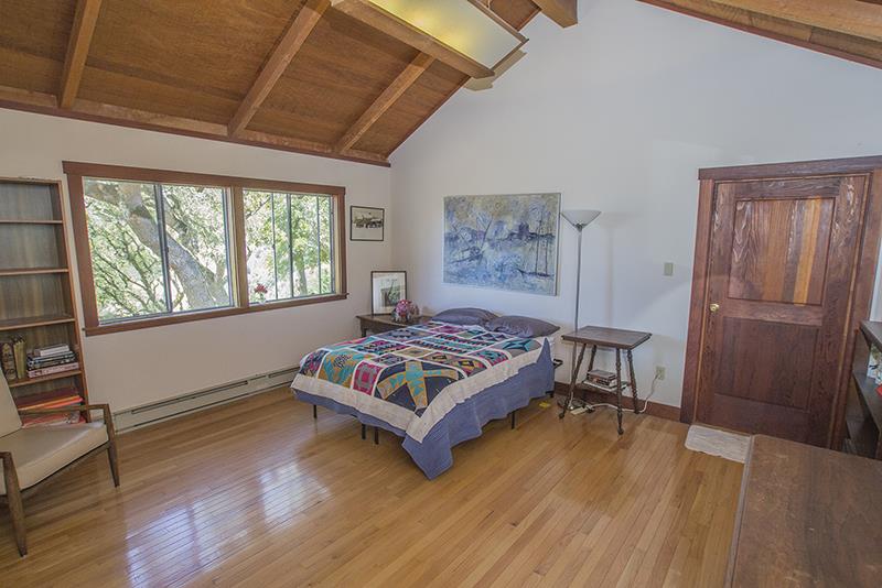 227 Rapley Ranch Road La Honda, CA 94020 - Photo 12 of 35 a bed sitting in a bedroom next to a window