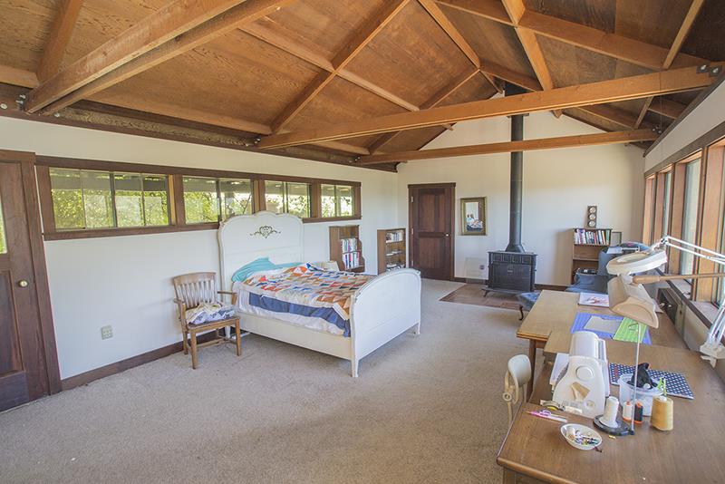 227 Rapley Ranch Road La Honda, CA 94020 - Photo 19 of 35 a bedroom with furniture and a window