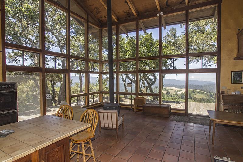 227 Rapley Ranch Road La Honda, CA 94020 - Photo 5 of 35 a view of a dining room with furniture large windows and wooden floor