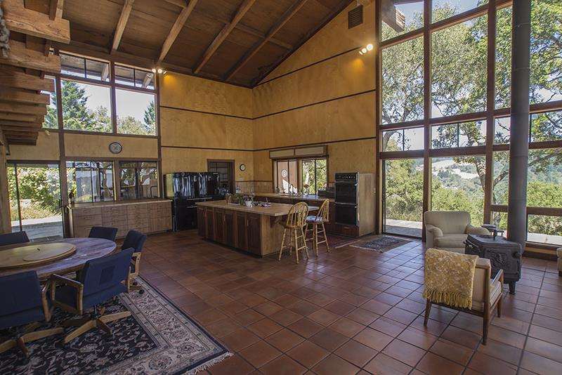 227 Rapley Ranch Road La Honda, CA 94020 - Photo 6 of 35 a living room with couches a dining table and chairs with outer view
