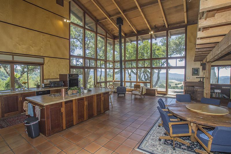 227 Rapley Ranch Road La Honda, CA 94020 - Photo 8 of 35 a kitchen with a stove a sink and a table with chairs