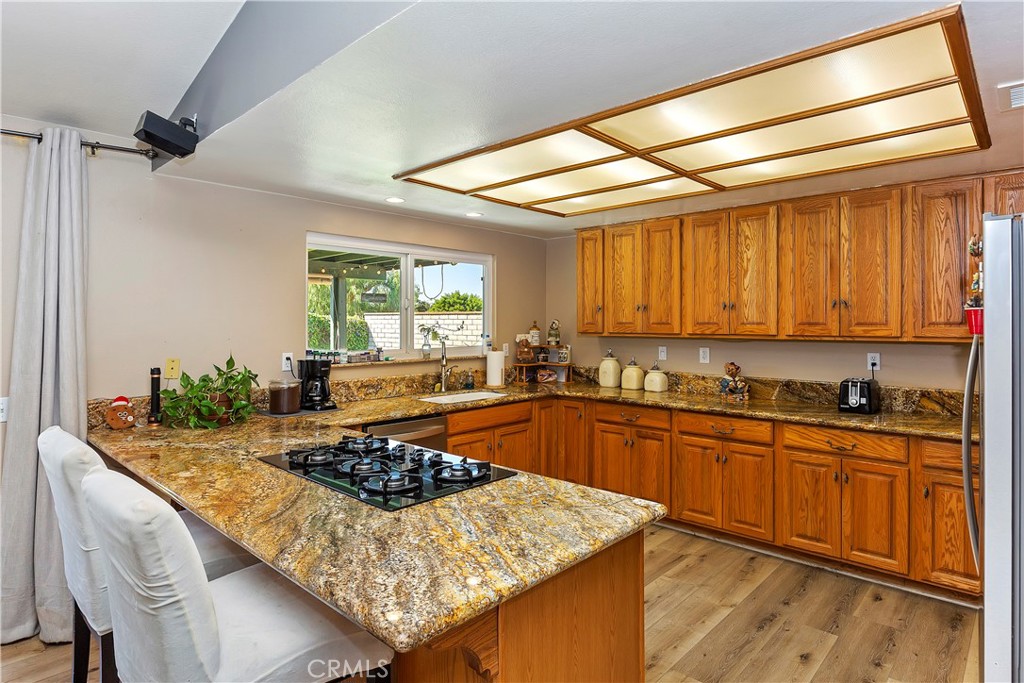 17411 Kaison Circle Riverside, CA 92508 - Photo 16 of 51 a kitchen with a stove a sink and a refrigerator
