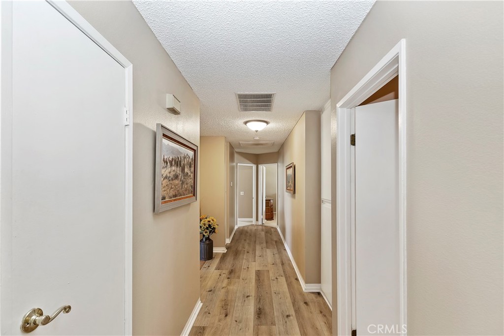 17411 Kaison Circle Riverside, CA 92508 - Photo 21 of 51 a view of a hallway with wooden floor and staircase