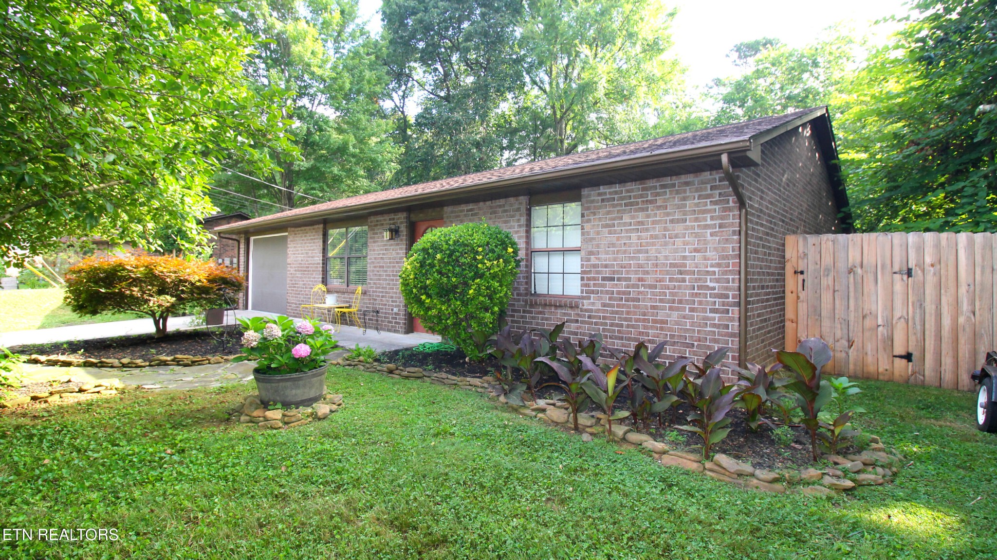 2523 Chukar Road Knoxville, TN 37923 - Photo 1 of 33 a backyard of a house with garden and plants
