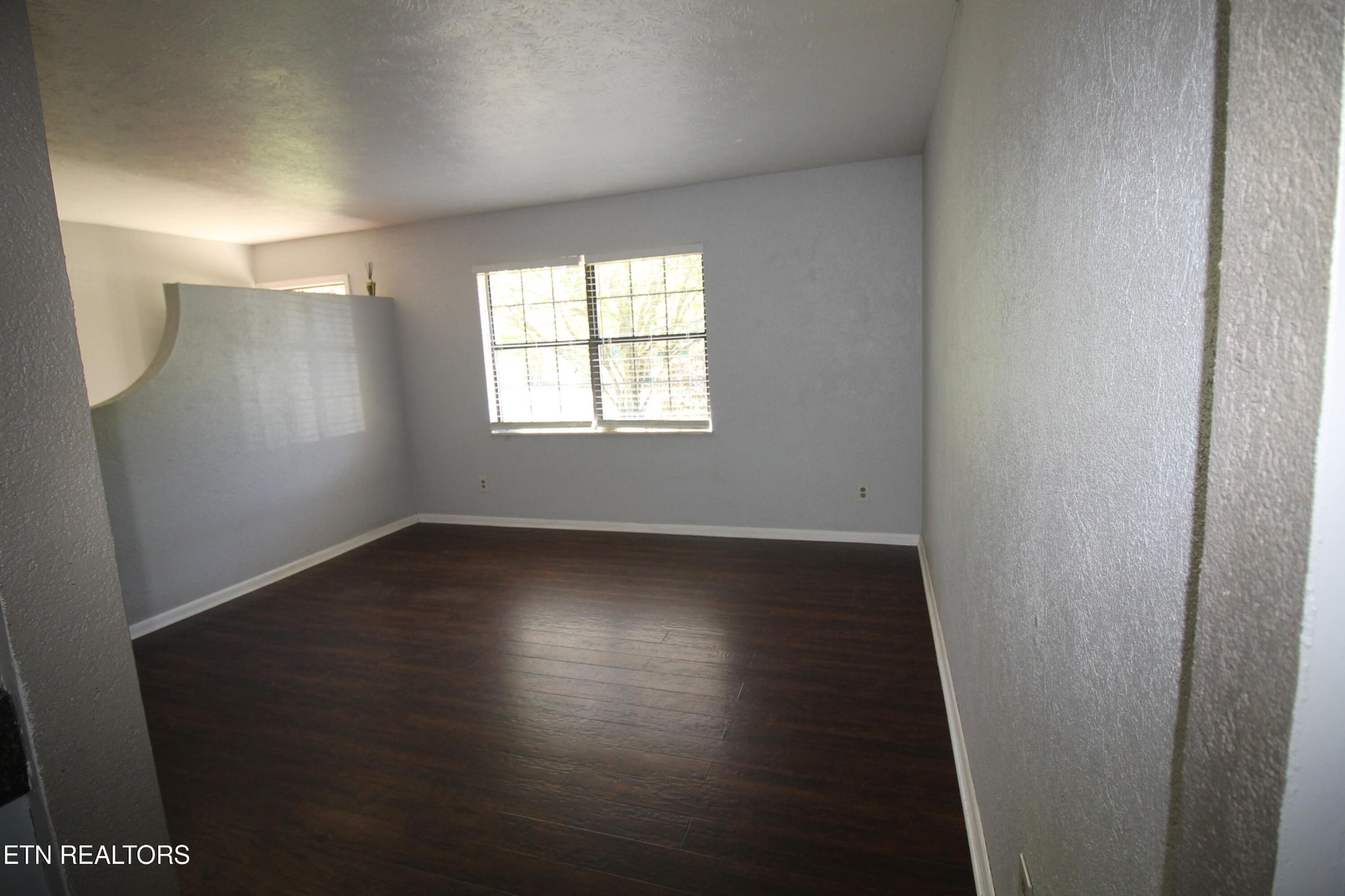 2523 Chukar Road Knoxville, TN 37923 - Photo 28 of 33 an empty room with wooden floor and windows