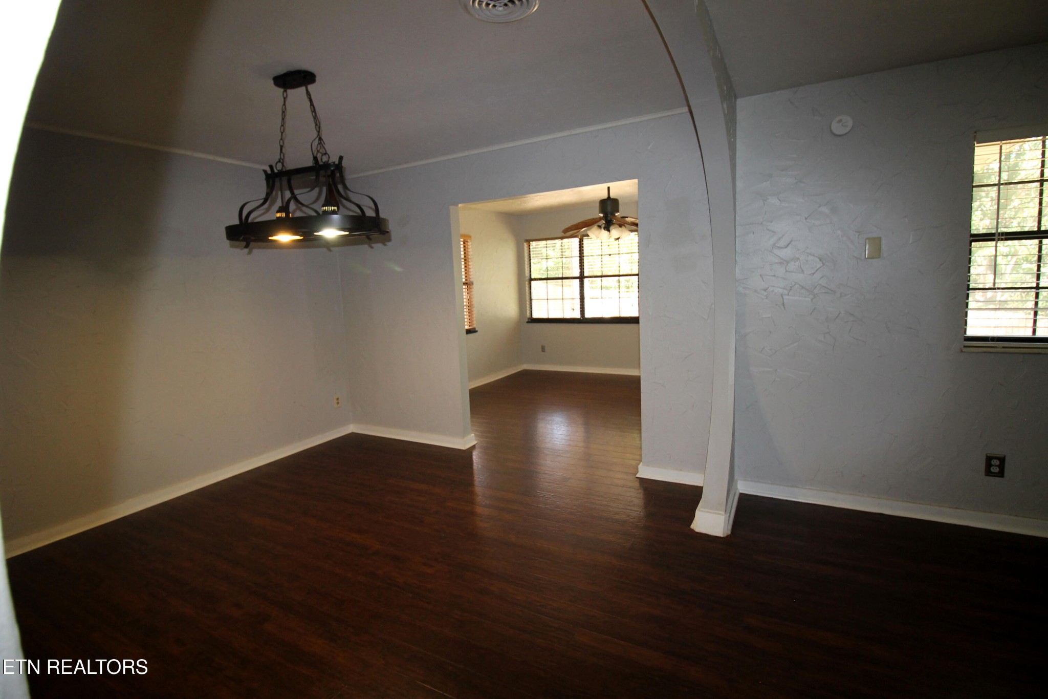 2523 Chukar Road Knoxville, TN 37923 - Photo 9 of 33 an empty room with wooden floor chandelier and windows