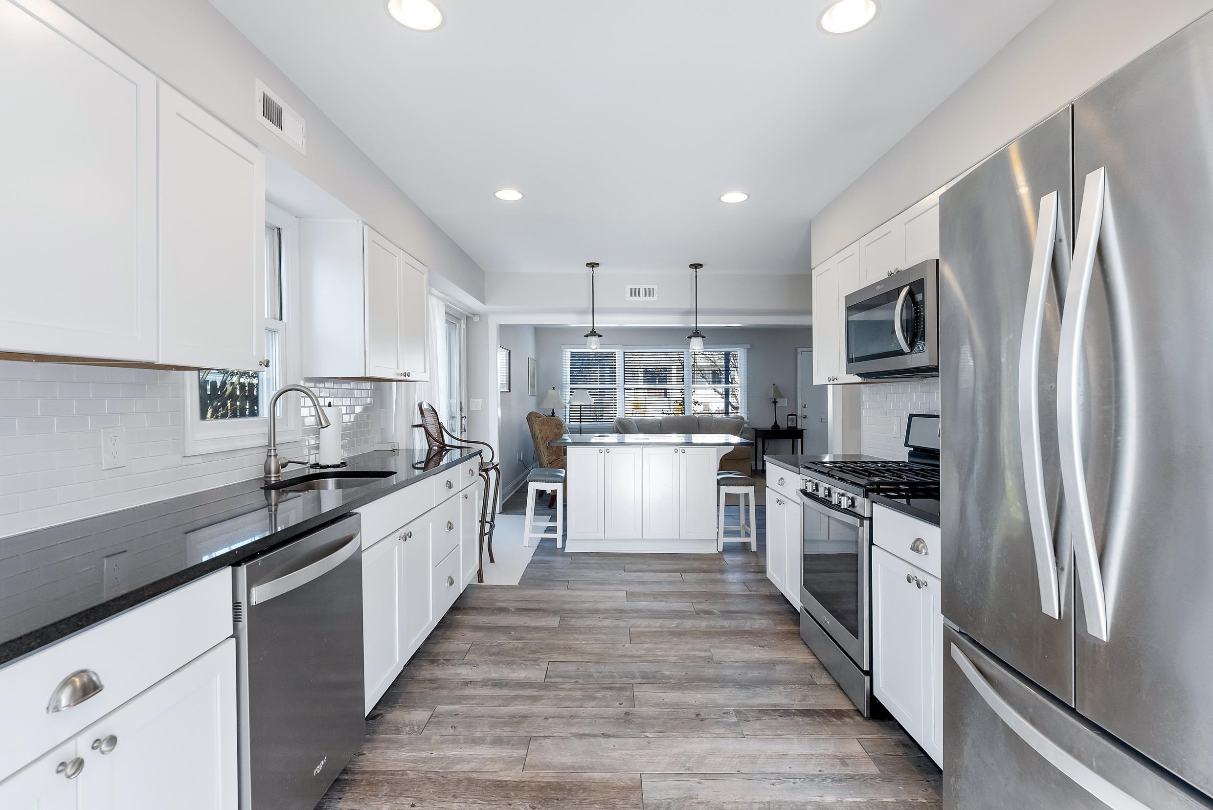 274 52nd Street Avalon, NJ 08202 - Photo 22 of 39 a large kitchen with stainless steel appliances granite countertop a stove top oven a refrigerator a sink and dishwasher
